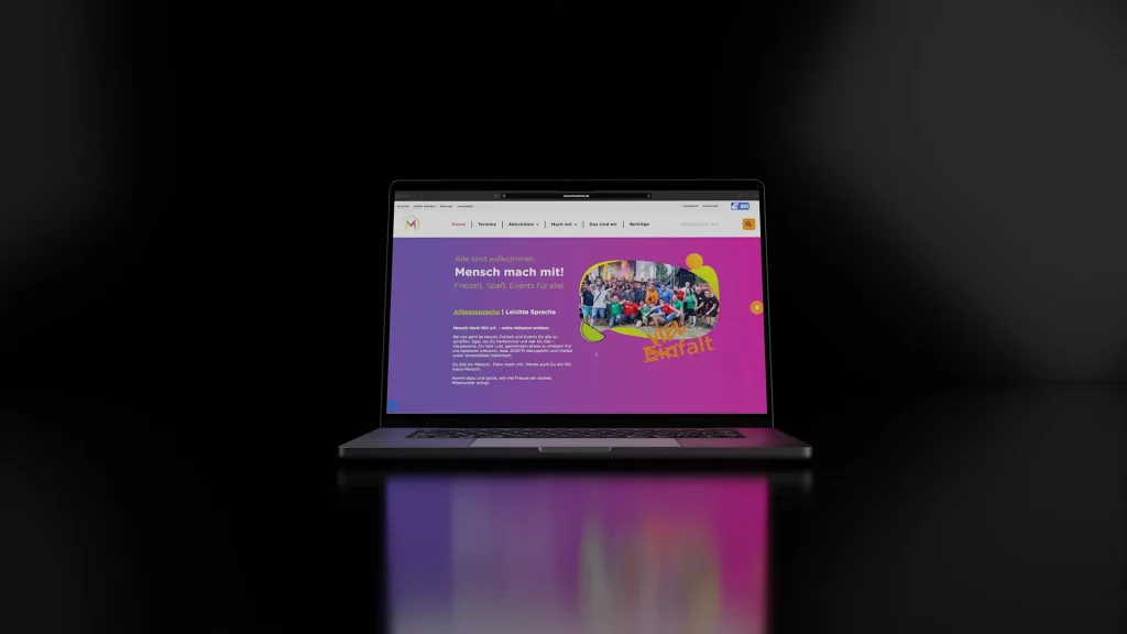 Neue Startseite der Vereinswebsite Mensch Mach Mit e.V. mit lila-pinkem Hero-Banner und Gruppenfoto, umgesetzt im WordPress Relaunch